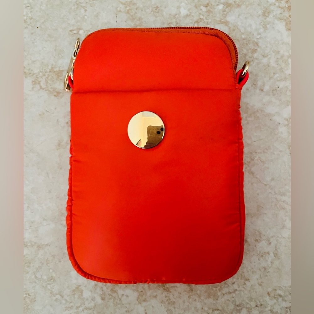 Orange Nylon Cell phone crossbody . Has zipper top , front pocket & back zipper.